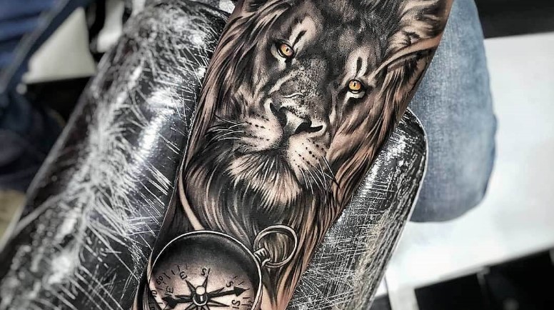 10. Lion and Compass Tattoo for Men - wide 4